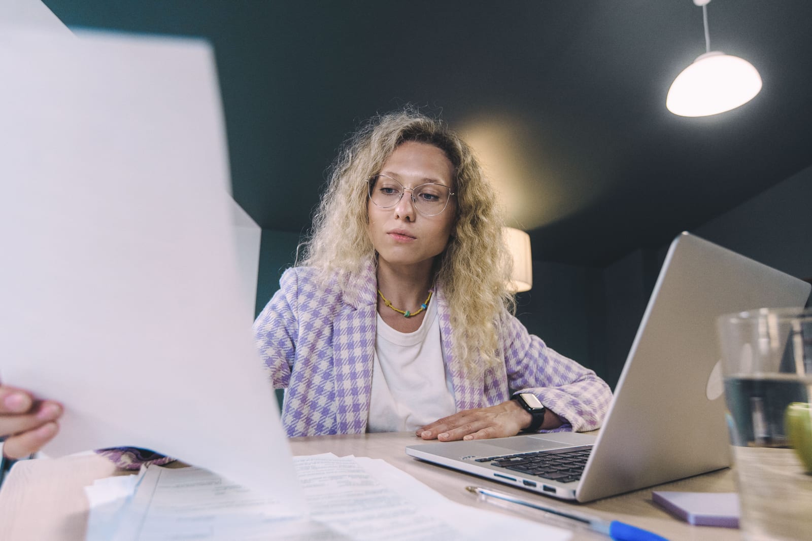 Woman reviewing a laptop screen in a bright modern office